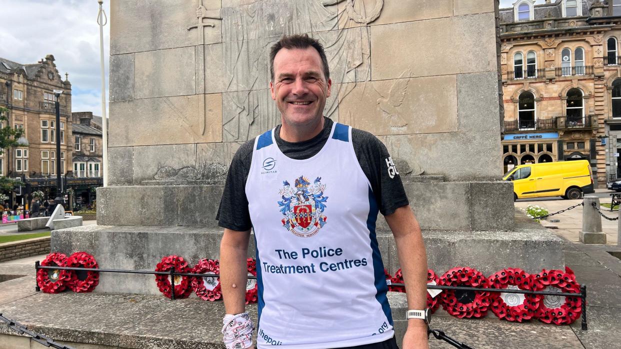 Sgt Cording standing in front of Harrogate Cenotaph