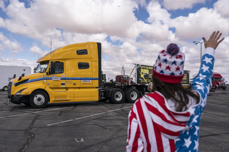 Supporters cheer on the beginning of a trucker caravan to Washington, D.C., called The People's Convoy Wednesday, Feb. 23, 2022, in Adelanto, Calif. A small convoy of truckers demanding an end to coronavirus mandates began a cross-country drive from California to the Washington, D.C., area on Wednesday. (AP Photo/Nathan Howard)