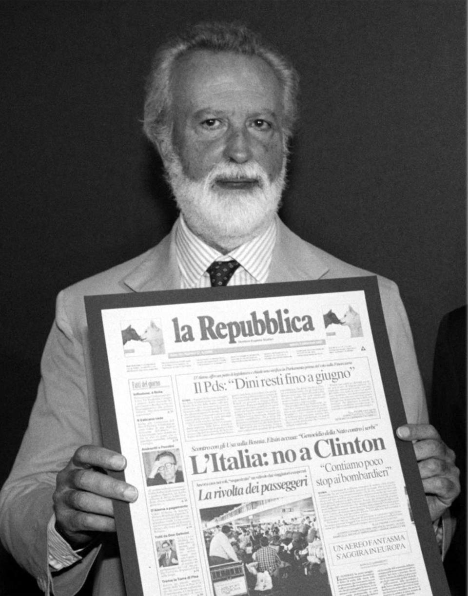 FILE - Journalist Eugenio Scalfari poses with an edition of La Repubblica newspaper, in Milan, in this 1992 photo. Eugenio Scalfari, who revolutionized Italian journalism with the creation of La Repubblica, a liberal daily that boldly challenged traditional newspapers, died on Thursday, July, 14, 2022, the Senate president announced. He was 98. (Ap Photo/Files)