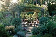 <p>With a structure to grow on, plants in this New York garden can create living walls that offer privacy and seclusion. Here, a cedar arbor boasts a dense covering of roses that forms a natural "roof," while a boxwood shrub anchors the base of each column. The result is an intimate seating area that can be used for relaxing or dining.</p><p><strong><a href="https://www.countryliving.com/gardening/garden-tours/g200/garden-getaway-0606/" rel="nofollow noopener" target="_blank" data-ylk="slk:Read more about this New York garden;elm:context_link;itc:0;sec:content-canvas" class="link ">Read more about this New York garden</a>.</strong> </p>