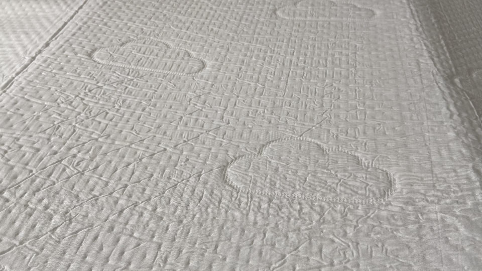 Close up of Puffy Deluxe Mattress Topper cover
