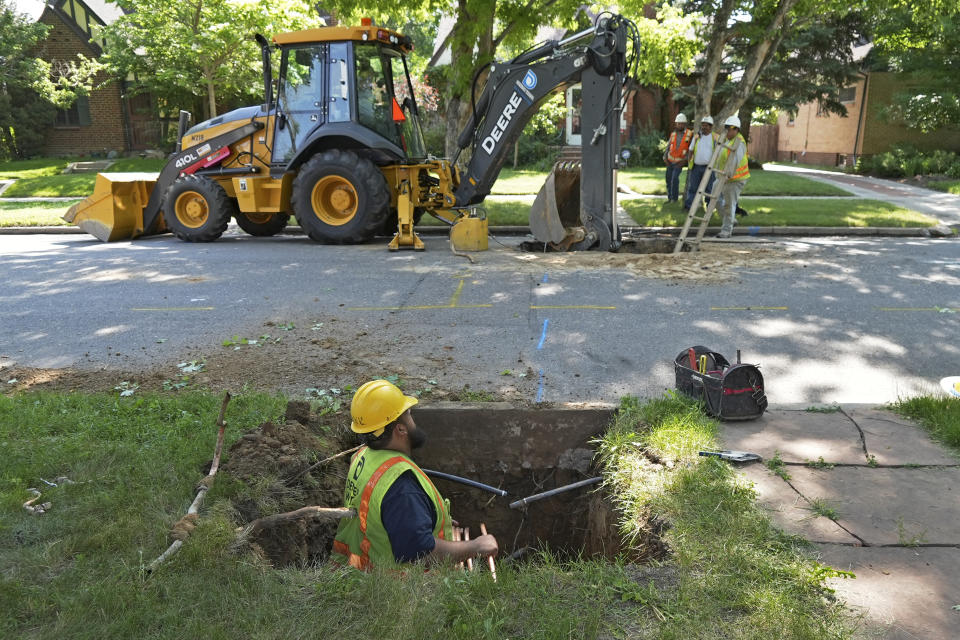 A Denver Water crew works to replace a lead water service line installed in 1927 with a new copper one at a private home on Thursday, June 17, 2021, in Denver. While President Joe Biden's infrastructure bill proposes $45 million for eliminating lead pipes and service lines, some utility companies and municipalities have already started replacing them. (AP Photo/Brittany Peterson)