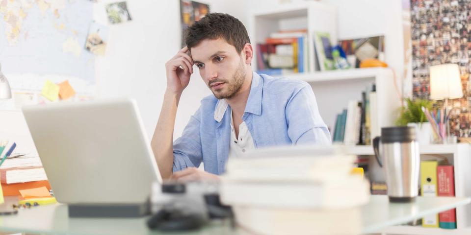 young student works on his laptop at home