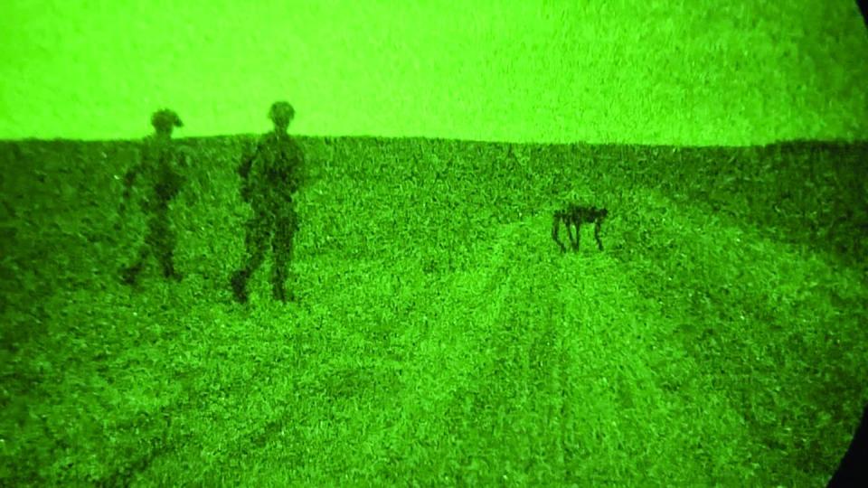U.S. soldiers walk alongside a Ghost Robotics-made Vision 60 robotic dog on Fort Liberty, N.C., in Aug. 14, 2023. The unmanned system features a camera, explosive ordnance disposal tools and the ability to carry heavy payloads. (Sgt. Jacob Moir/U.S. Army)
