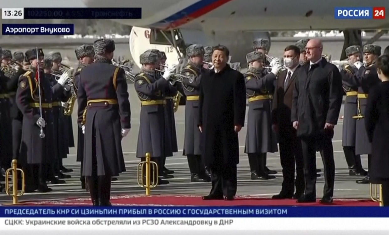 In this grab taken from video provided by RU-24, China's President Xi Jinping stands, during an official welcome ceremony upon his arrival at the Vnukovo-2 government airport outside Moscow, Monday, March 20, 2023. (RU- 24 via AP)