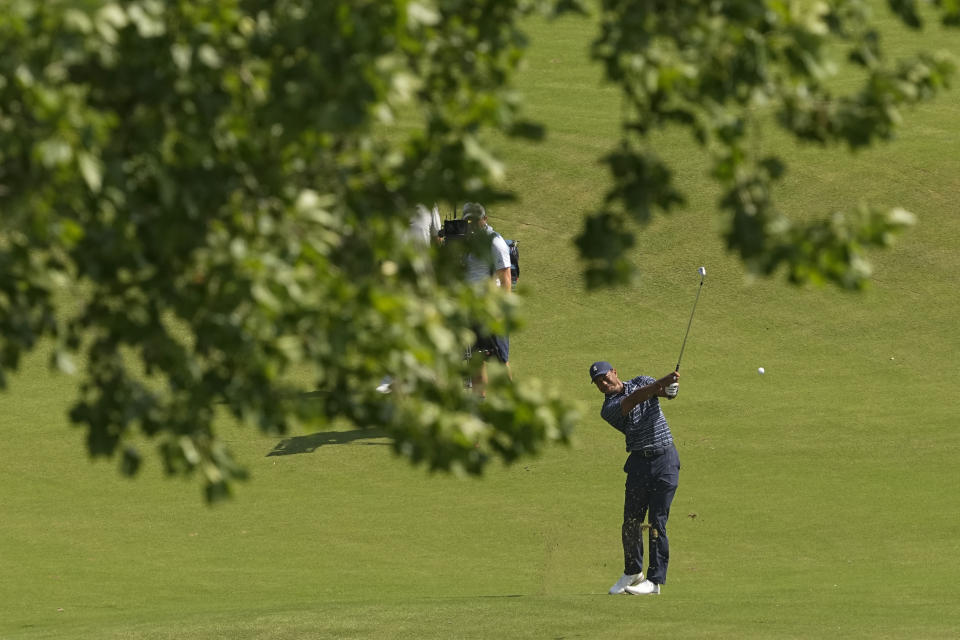 Tiger Woods hits from the fairway on the 18th hole during the first round of the PGA Championship golf tournament, Thursday, May 19, 2022, in Tulsa, Okla. (AP Photo/Matt York)