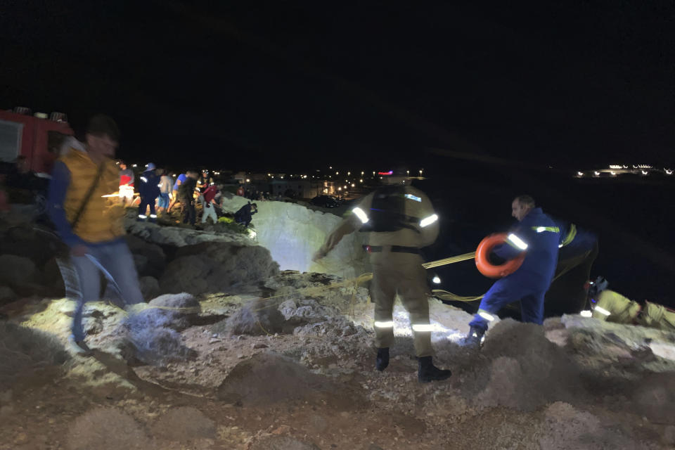 Authorities and local residents take part in a large-scale rescue operation on the island of Kythira, some 225 kilometers (140 miles) south of Athens, early Thursday, Oct. 6, 2022. The operation is underway off a southern Greek island where a sailboat carrying up to 100 migrants sank in high winds. The coast guard said its vessels, private boats and a rescue helicopter were involved in the effort off the coast of the island of Kythira. (Ippolytos Prekas/kythera.news via AP)