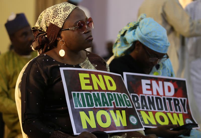 A demonstrator holds a sign during a protest to urge authorities to rescue hundreds of abducted schoolboys, in northwestern state of Katsina