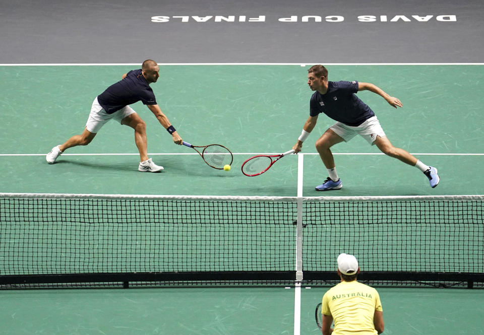 Britain's Daniel Evans, left, and Neal Skupski in action against Australia's Matthew Ebden and Daniel Purcell during the Davis Cup group stage doubles match at the AO Arena, Manchester, England, Wednesday, Sept. 13. 2023. (Martin Rickett/PA via AP)