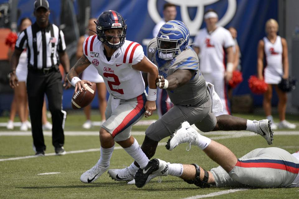 Mississippi quarterback Matt Corral (2) scrambles ahead of Memphis defensive lineman John Tate IV in the first half of an NCAA college football game Saturday, Aug. 31, 2019, in Memphis, Tenn. (AP Photo/Brandon Dill)