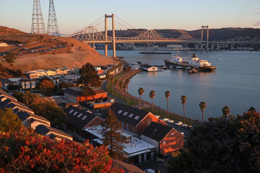 VALLEJO, CA - NOVEMBER 14: The Golden Bear training ship in the Carquinez Straight with the Alfred Zampa Memorial Bridge seen in the background, and the campus of The California State University Maritime Academy seen in the foreground left, on Monday, Nov. 14, 2022 in Vallejo, CA. Students at Cal Maritime say that a longstanding toxic and misogynistic culture neglects to protect those outside the white male dominated-majority. The Maritime campus is unlike any other CSU - its students are cadets and wear uniforms and they are largely white and 80% male, with most getting jobs in the maritime industry. (Gary Coronado / Los Angeles Times)