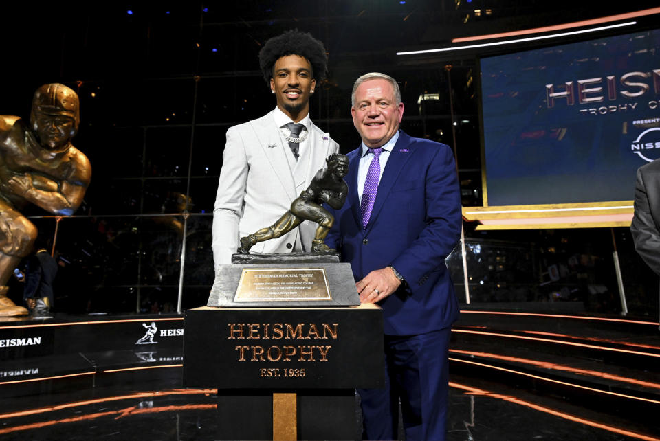 LSU football coach Brian Kelly, right, stands with quarterback Jayden Daniels, who won college football's Heisman Trophy on Saturday, Dec. 9, 2023, in New York. (Todd Van Emst/Pool Photo via AP)