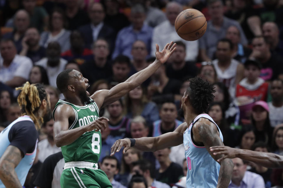 Boston Celtics guard Kemba Walker (8) goes to the basket past Miami Heat forward Chris Silva,right, during the first half of an NBA basketball game, Tuesday, Jan. 28, 2020, in Miami. (AP Photo/Lynne Sladky)