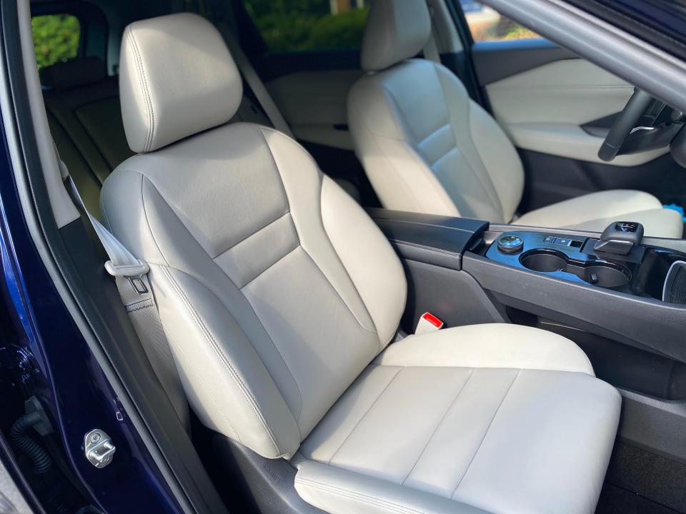 The white leather front passenger seat in a 2024 Nissan Rogue SL SUV.
