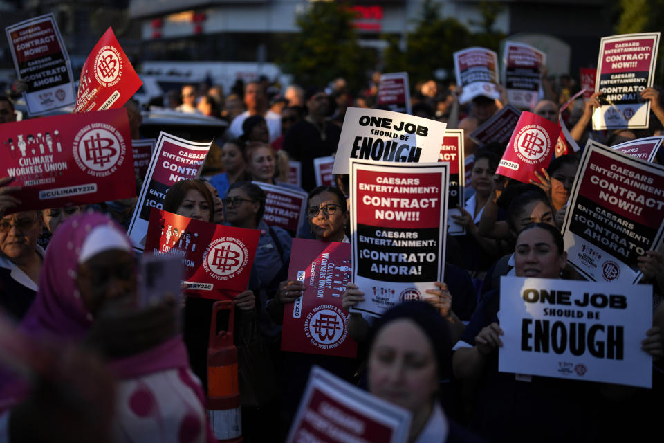 Members of the Culinary Workers Union rally along the Strip, Wednesday, Oct. 25, 2023, in Las Vegas. Thousands of hotel workers fighting for new union contracts rallied Wednesday night on the Las Vegas Strip, where rush-hour traffic was disrupted when some members blocked the road before being detained by police. (AP Photo/John Locher)