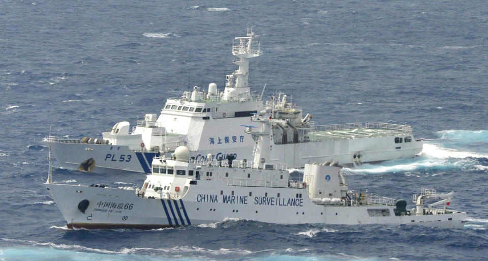 A Japan Coast Guard vessel sails along with Chinese surveillance ship Haijian No. 66, foreground, near disputed islands called Senkaku in Japan and Diaoyu in China,in the East China Sea, on Monday, Sept. 24, 2012. (AP Photo/Kyodo News) JAPAN OUT, MANDATORY CREDIT, NO LICENSING IN CHINA, HONG KONG, JAPAN, SOUTH KOREA AND FRANCE