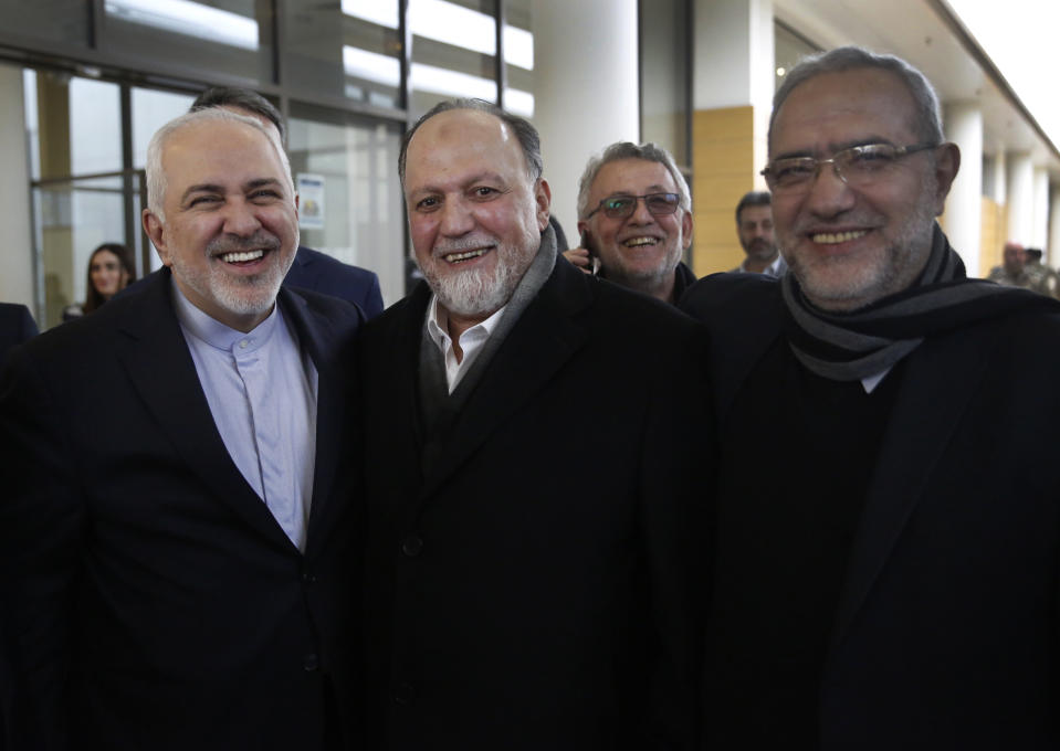 Iran's Foreign Minister Mohammad Javad Zarif, left, poses for a picture with Hezbollah lawmaker Ali Ammar, center, and Lebanese Minister of State Parliamentary Affairs Mahmoud Qmati, right, on his arrival at Rafik Hariri Airport, in Beirut, Lebanon, Sunday, Feb. 10, 2019. Zarif said his country is ready to cooperate with the new Lebanese government, offering his country's support in all sectors. (AP Photo/Hussein Malla)