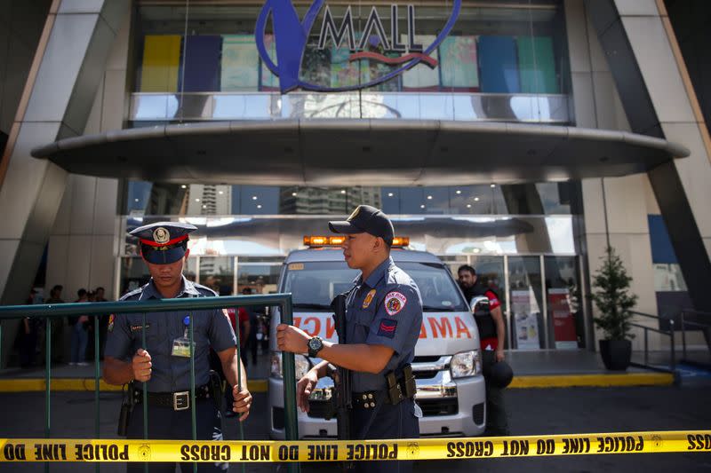 Police officers block the area outside Virra Mall where gunshots were fired, in San Juan City, Metro Manila