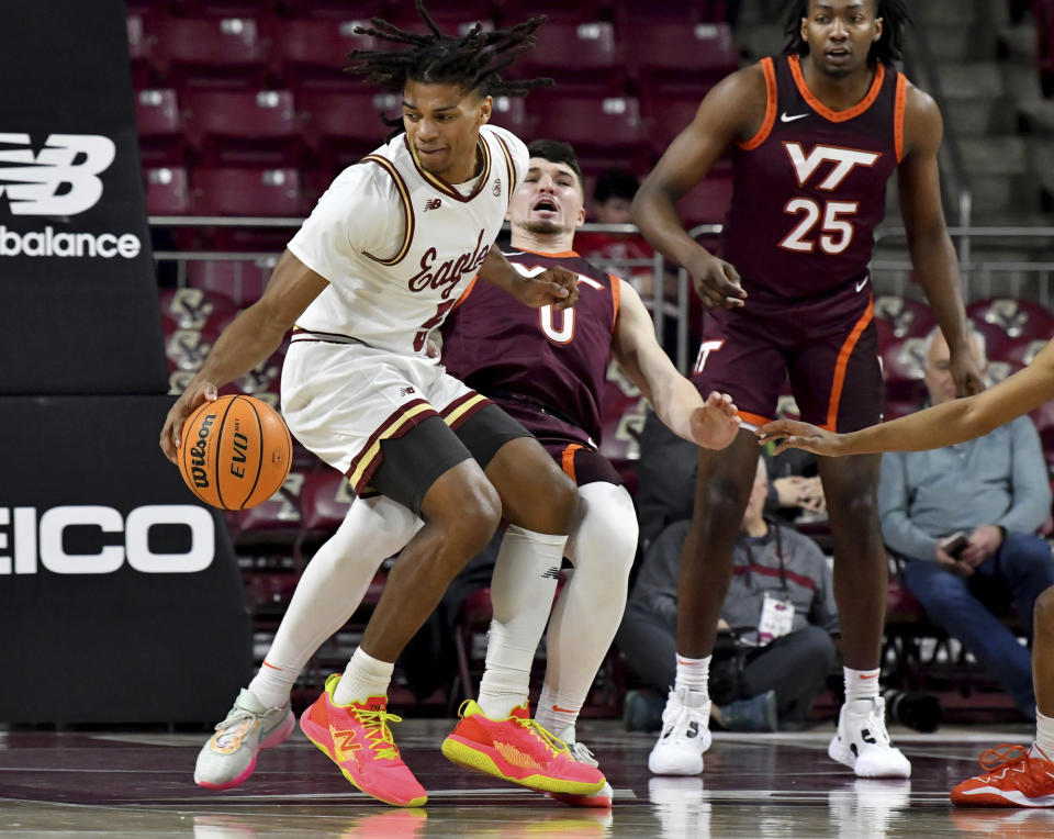 Boston College's DeMarr Langford Jr. knocks over Virginia Tech's Hunter Cattoor during the first half of an NCAA college basketball game, Wednesday, Dec. 21, 2022, in Boston. (AP Photo/Mark Stockwell)