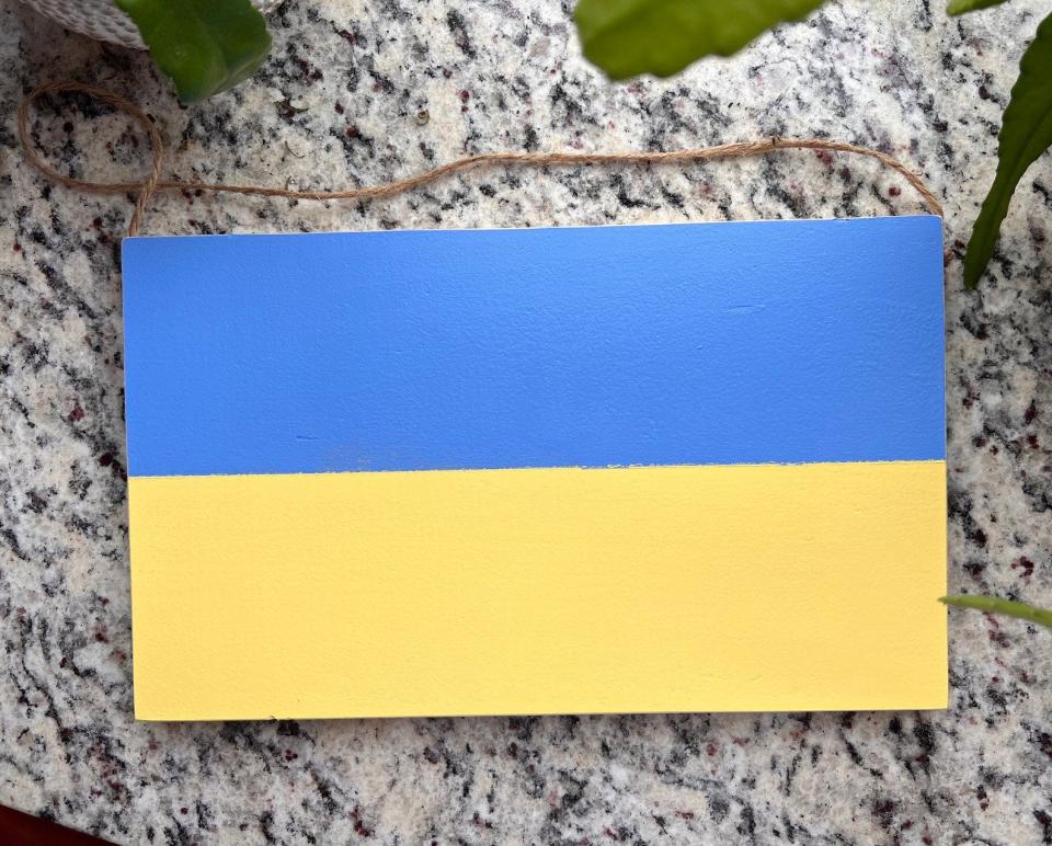 Wooden Ukraine colors are being sold by Kateryna Woodworks of Dover to help people in the war-torn nation.