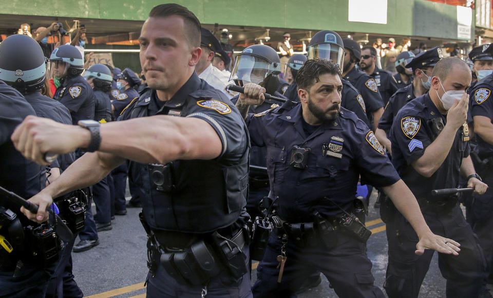 New York Police officers push back protesters during a demonstration Saturday, May 30, 2020, in the Brooklyn borough of New York. Protests were held throughout the city over the death of George Floyd, a black man who was in police custody in Minneapolis. Floyd died after being restrained by Minneapolis police officers on Memorial Day. (AP Photo/Seth Wenig)