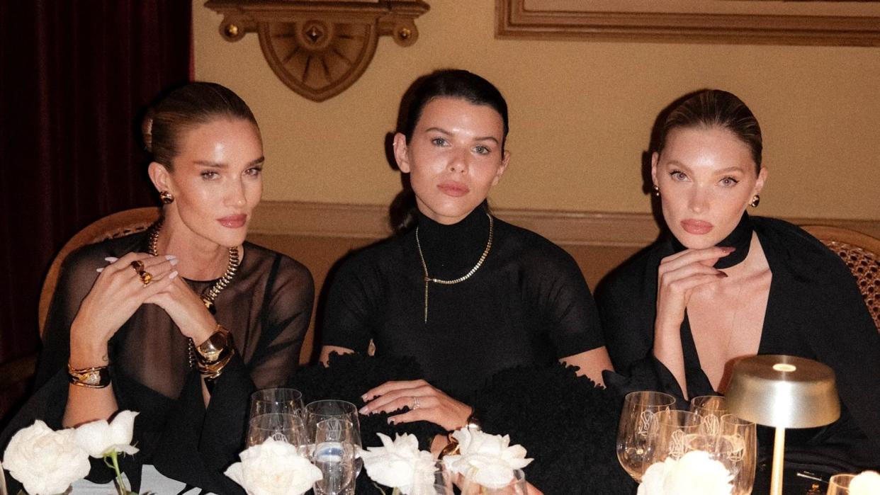 Rosie Huntington Whitely, Georgia Fowler and Elsa Hosk pose for a photo at dinner in black dresses