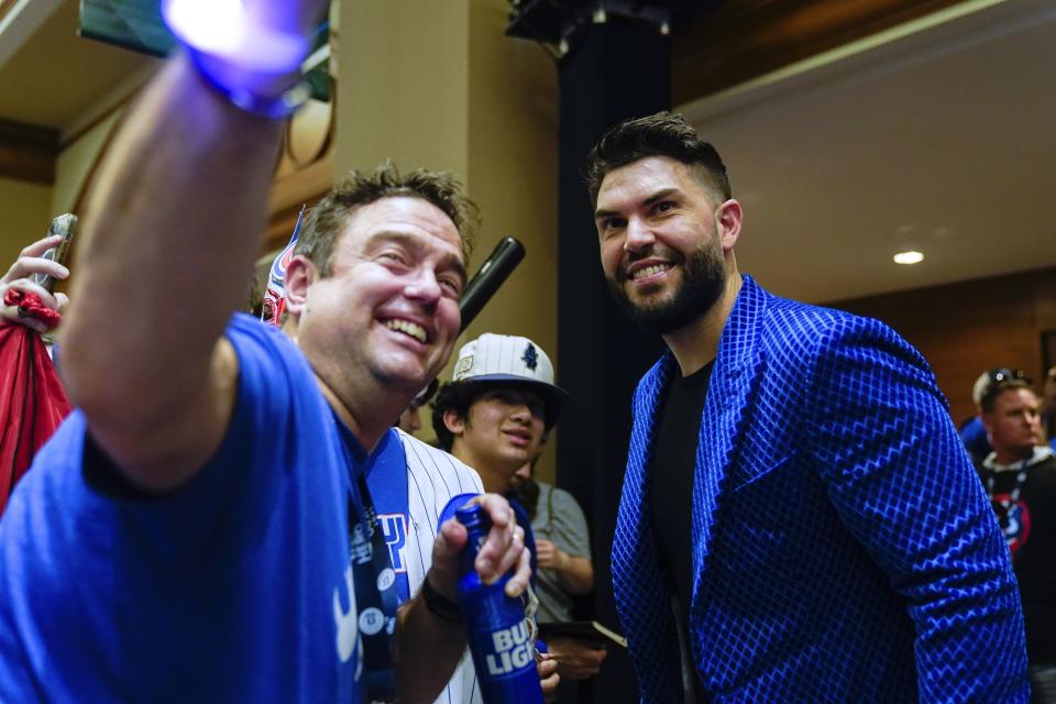 Chicago Cubs first baseman Eric Hosmer, right, poses for a photo with a fan on the opening day of the Cubs' fan convention Friday, Jan. 13, 2023, in Chicago. (AP Photo/Erin Hooley)