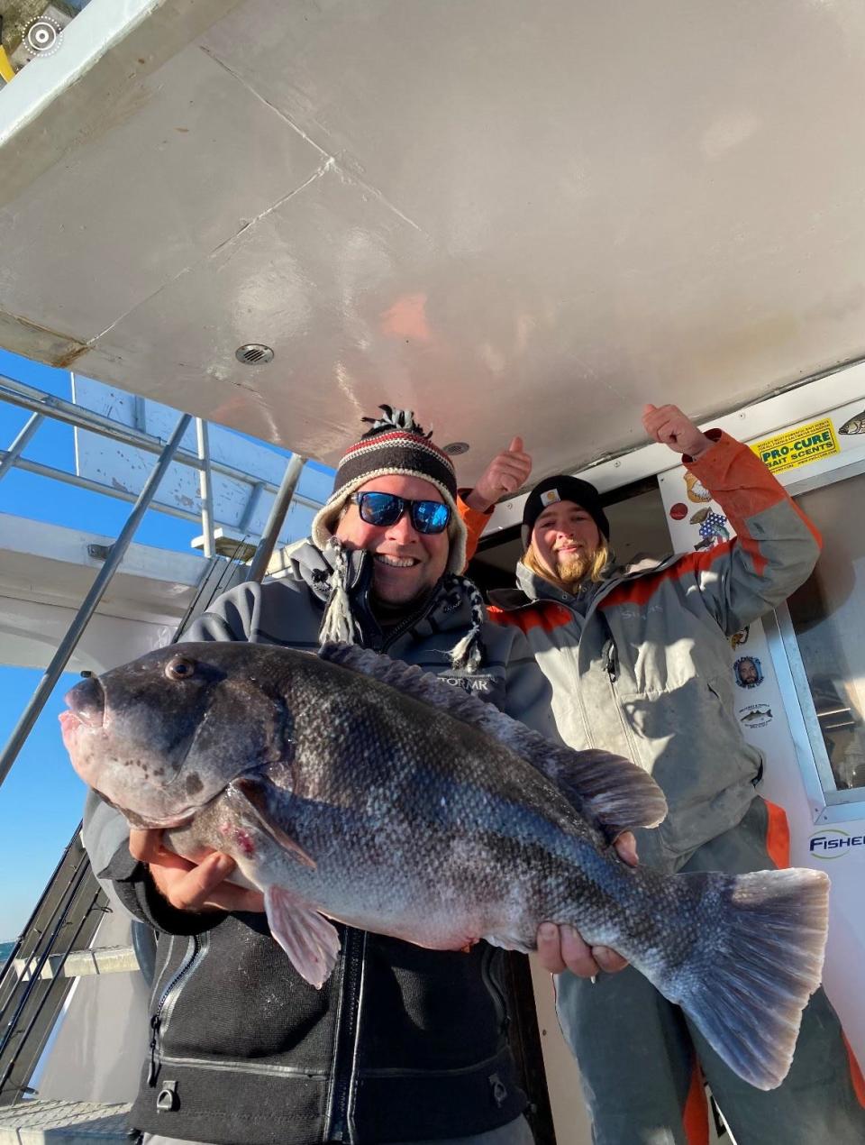 Capt. Matt Sosnowski, skipper of the Big Mohawk, holds the 13-pound blackfish he caught Monday. On his right is Capt. Peyton Gepp.