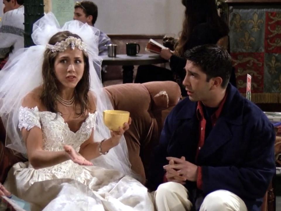 Jennifer Aniston and David Schwimmer sitting on a couch on the series premiere of "Friends."