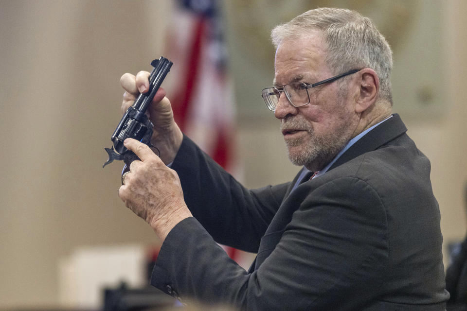 Lucien Haag, a witness on forensic science firearms evidence examination and shooting reconstruction, shows the jury a gun like the one used in rehearsal for the film "Rust" during the Hanna Gutierrez-Reed trial at District Court in Santa Fe, N.M., on Tuesday, Feb. 27, 2024. (Luis Sánchez Saturno/Santa Fe New Mexican via AP, Pool)