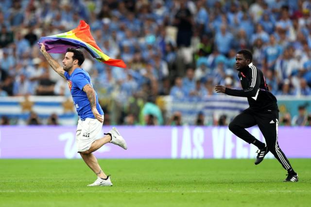 Pitch invader with rainbow flag interrupts World Cup match between Portugal  and Uruguay, Pro Sports