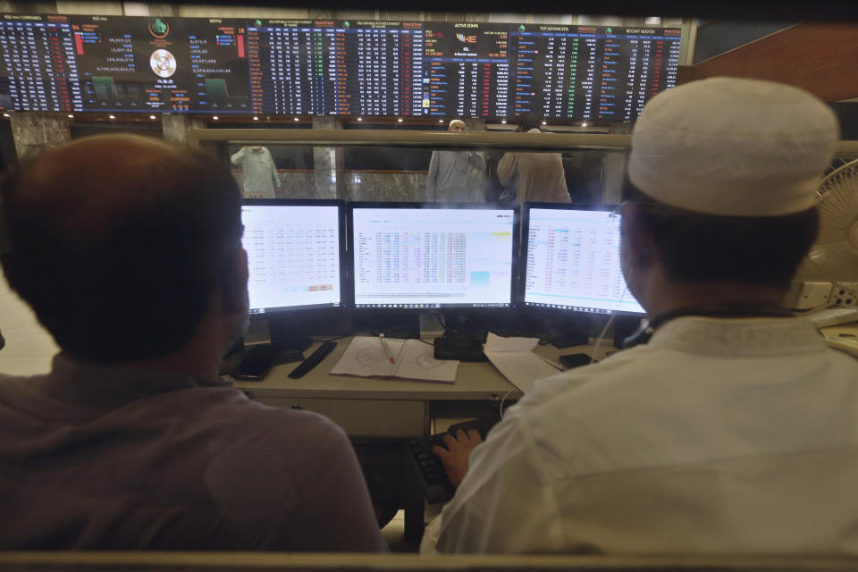 Pakistani brokers monitor Index on their monitors at at the Pakistan Stock Exchange (PSE), in Karachi, Pakistan, Friday, June 24, 2022. Pakistan's stock market suddenly fell by three percent on Friday, shortly after the government of recently elected Prime Minister Shahbaz Sharif suddenly announced the imposition of additional taxes on the corporate and banking sector in an effort aimed at stabilizing the country's fledgling economy. (AP Photo/Fareed Khan)