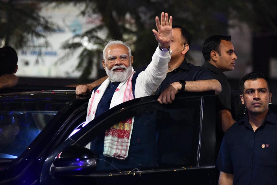 Modi waves to supporters during an appearance at an election campaign rally in the northeastern city of Guwahati in April (AFP via Getty)