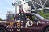Rodney Johnson of Chesapeake, Va., sits in his truck outside FedEx Field in Landover, Md., Monday, July 13, 2020. The Washington NFL franchise announced Monday that it will drop the "Redskins" name and Indian head logo immediately, bowing to decades of criticism that they are offensive to Native Americans. (AP Photo/Susan Walsh)