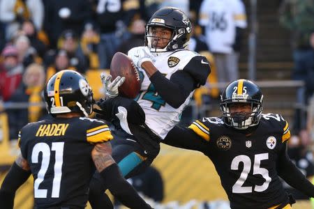 Jan 14, 2018; Pittsburgh, PA, USA; Jacksonville Jaguars wide receiver Keelan Cole (84) catches a pass between Pittsburgh Steelers cornerback Artie Burns (25) and Steelers cornerback Joe Haden (21) during the second half in the AFC Divisional Playoff game at Heinz Field. Mandatory Credit: Geoff Burke-USA TODAY Sports