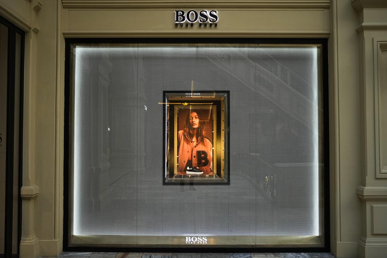 A showcase of the BOSS boutique closed due to sanctions in the GUM department store in Moscow, Russia, Tuesday, Aug. 9, 2022. Often, it's hard to tell when stores are closed. At the famous GUM department store lined with shops in Red Square, most of the closed storefronts still had the lights on and a clerk or guard inside. (AP Photo/Alexander Zemlianichenko)