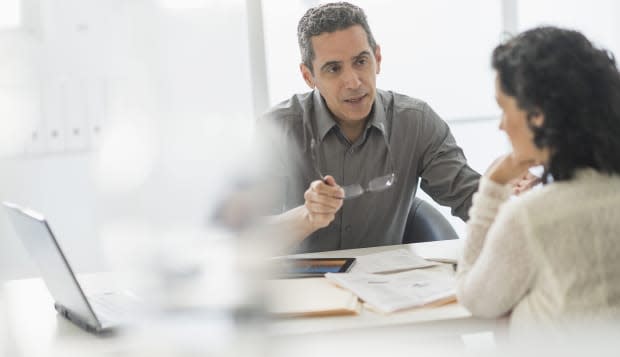 USA, New Jersey, Business people talking at desk in office