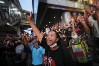 Pro-democracy demonstrators flash a three-finger salute of defiance during a protest rally at the Silom business district in Bangkok, Thailand, Thursday, Oct. 29, 2020. The protesters continue to gather Thursday with their three main demands of Prime Minister Prayuth Chan-ocha's resignation, changes to a constitution that was drafted under military rule and reforms to the constitutional monarchy. (AP Photo/Sakchai Lalit)