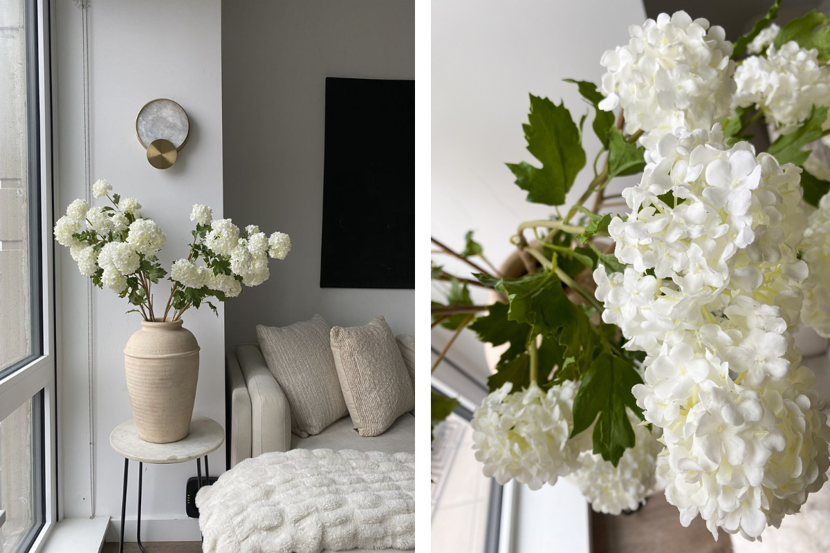 a white vase with white flowers