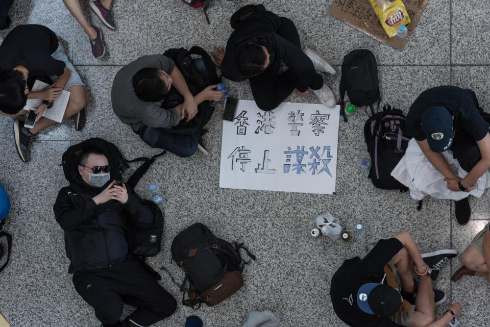 HONG KONG INTERNATIONAL AIRPORT, HONG KONG, NEW TERRITORIES, CHINA - 2019/08/13: Protesters relax in a circle during the demonstration. Anti-government protesters peacefully sat-in at the Hong Kong International Airport for the 5th consecutive day until later in the evening where various events led to intense confrontation and violence with the police. The sit-in led to mass flight cancellations and aimed to raise international awareness of protesters' fight against the extradition bill and of police brutality at the protest. (Photo by Aidan Marzo/SOPA Images/LightRocket via Getty Images)