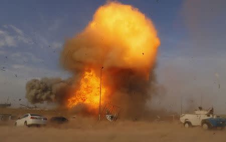An explosion is seen during a car bomb attack at a rally held by Shi'ite political organisation Asaib Ahl Haq (League of the Righteous) in Baghdad, in this April 25, 2014 file photo. REUTERS/Thaier Al-Sudani/Files