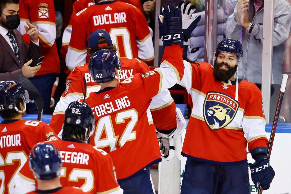 Florida Panthers defenseman Radko Gudas (7) high-fives defenseman Gustav Forsling (42) after an NHL hockey game against the Arizona Coyotes, Monday, Oct. 25, 2021, in Sunrise, Fla. (AP Photo/Michael Reaves)