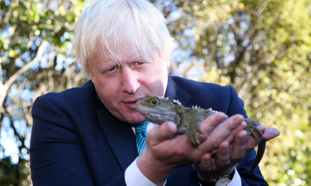 Boris Johnson holds a tuatara reptile during his visit to Wellington, New Zealand. 