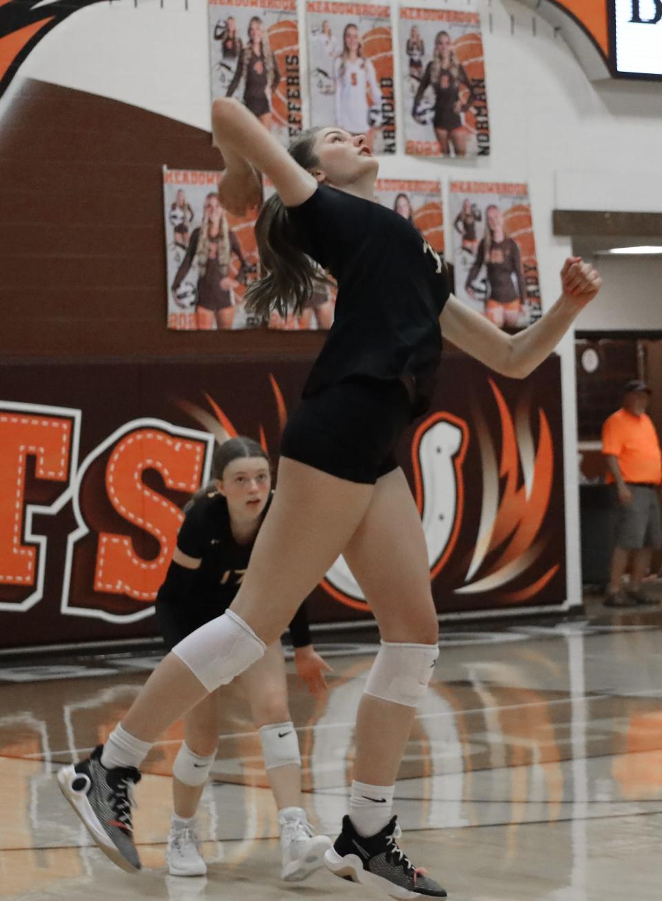 Tri-Valley's Eva Dittmar (14) jumps to spike the ball during the Tuesday's volleyball game at Meadowbrook High School.