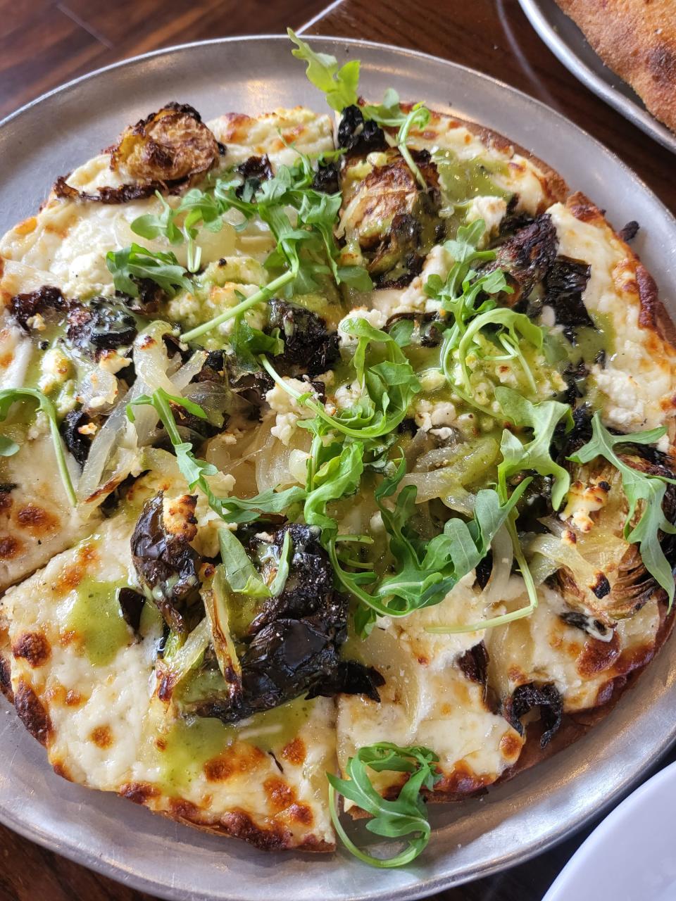 A white pizza topped with Brussels sprouts and goat cheese at Union 15 in Colonial Gardens should be on every pizza lover's Louisville list.