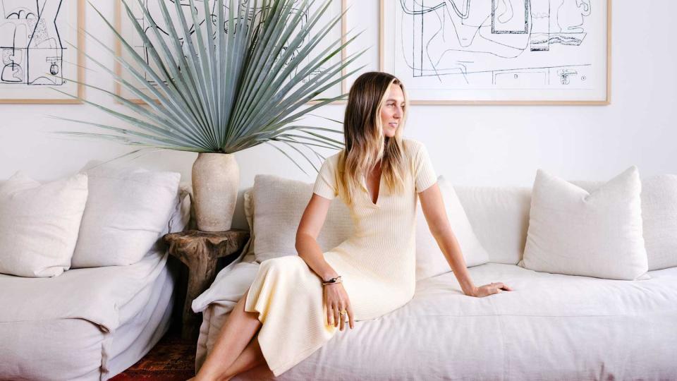Hotelier Emma Goodwin sits on a sofa in the library of her Surfrider Hotel, in Malibu