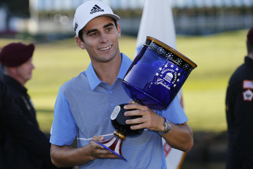 Joaquin Niemann, of Chile, holds the winners trophy as he celebrates winning the A Military Tribute at The Greenbrier golf tournament in White Sulphur Springs, W.Va., Sunday, Sept. 15, 2019. Niemann finished the tournament at 21-under-par. (AP Photo/Steve Helber)