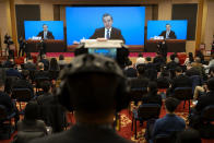 Chinese Foreign Minister Wang Yi speaks during a remote video press conference held on the sidelines of the annual meeting of China's National People's Congress (NPC) in Beijing, Sunday, March 7, 2021. (AP Photo/Mark Schiefelbein)