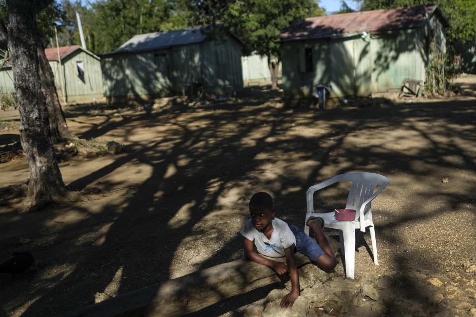 A Haitian child plays in the Batey La Lima community, an impoverished community surrounded by a massive sugarcane plantation in the coastal city of La Romana, Dominican Republic, Wednesday, Nov. 17, 2021. Activists say hostility against Haitians is spiraling as President Luis Abinader unleashed a flurry of anti-Haitian actions, including suspending a student-visa program for Haitians. (AP Photo/Matias Delacroix)