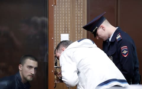 Pavel Ustinov listens to his lawyer from the defendant's cage on Monday - Credit: Evgenia Novozhenina/Reuters&nbsp;